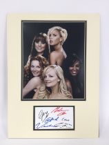 A mounted display of The Spice Girls with signatur