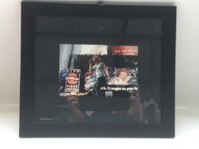 A framed and glazed signed photo of Jon Bon Jovi,