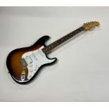 A Squier Stratocaster guitar in Fender Tweed Case