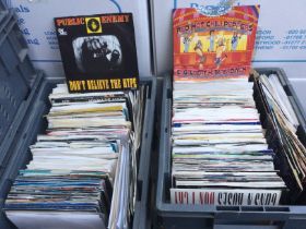 Four small plastic crates of 7inch singles by vari