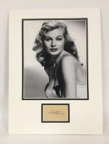 A mounted display of Anita Ekberg with signature a