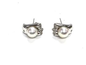 A pair of 14ct white gold pearl and diamond set ea