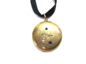 An 18ct gold locket set with diamond and sapphires