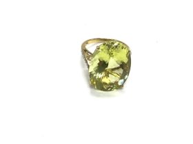 A 9ct gold ring set with large pale green stone. S