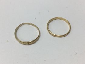 One 18ct band and one 14ct band, approx weight 2.9