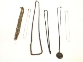 A collected of silver and other metal chains. Post