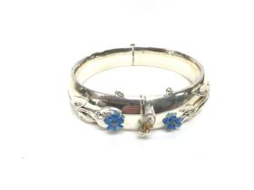 A silver bracelet with floral design. 70g and 7.5c
