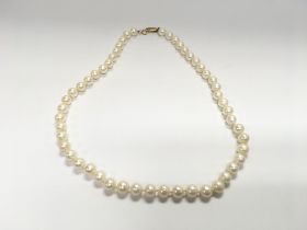 A cultured Pearl string necklace with 9ct gold cla