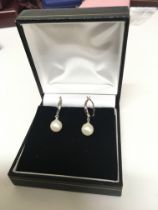 A pair of 9carat white gold and pearl drop earring