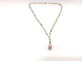 A cultured string of pearls on a 10ct chain. 43cm.