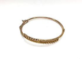 A 9ct gold bangle. 4.65g and 6cm diameter. Postage