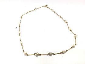 An 18ct gold link necklace with pearls. 50cm lengt