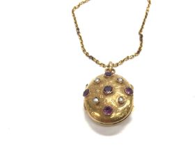 A high grade gold pendant inset with pearls and am