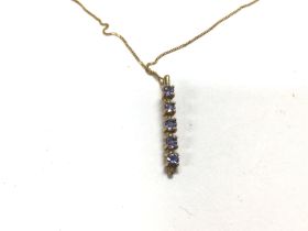 A 9ct gold chain with gold necklace set with blue