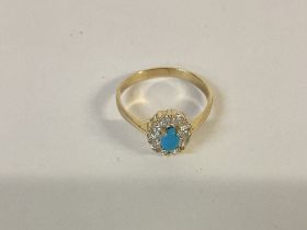A 14ct gold ring set with turquoise and white ston