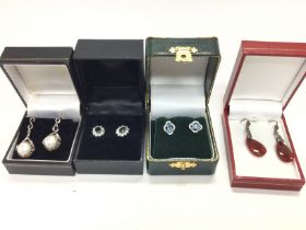 Four pairs of earrings including a pair set with p