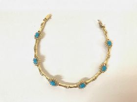 A 14ct gold bracelet set with turquoise and white