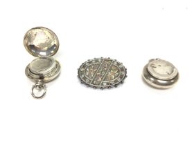 Two silver sovereign cases and a brooch. Postage B