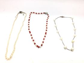 Three pearl necklaces of various styles. Postage B