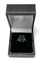 A 9ct gold ring set with a green polished hardston