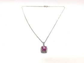 A silver chain with a pink stone pendant. 5.68g an