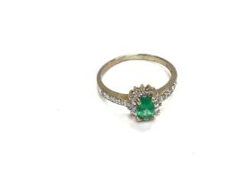 A 9ct gold ring set with green and white stones. S