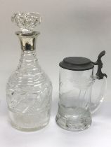 A wine decanter with a silver collar and an etched glass tankard (2). Shipping category D.