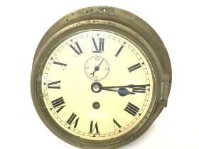 A brass ship clock , diameter of 20cm. Crack in gl