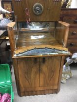 An Art Deco Burr walnut cocktail cabinet with a hi