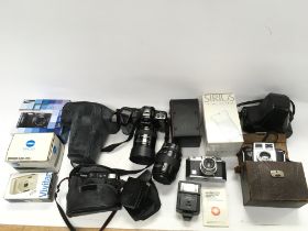 A collection of various cameras and camera equipme