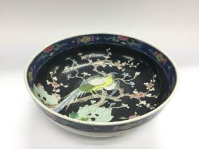 An Oriental bowl decorated with a bird amongst fol