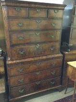 A walnut chest on chest fitted with three short an