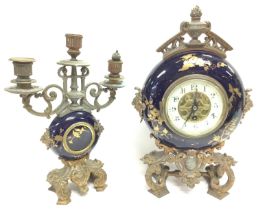 A brass and enamel table clock with candelabra gar
