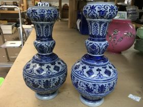 A pair of German pottery vases on blue ground. Hei
