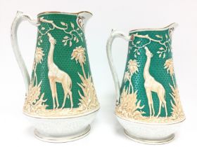 Two Victorian ceramics jugs decorated with Giraffes, one damaged with a hairline crack and a chip.