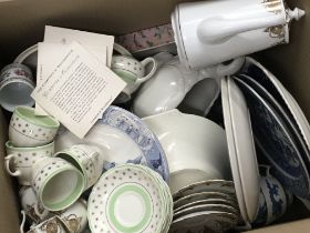 A box containing decorative ceramics blue and whit