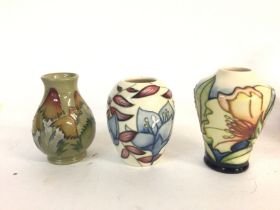 A collection of three small Moorcroft vases. Large