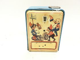 A vintage childs money box. 9.5cm wide and 13cm ta