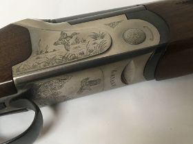 A 12bore shotgun maker Lanber with over and under 28inch barrel interchangeable chokes. The action