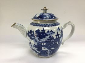 An 18th Century Chinese blue and white teapot decorated with pagodas. Shipping category D.