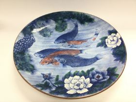 An Oriental charger depicting Koi carp, approx dia