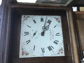 A oak long case clock the enamel painted dial with