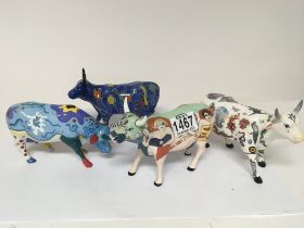 A collection of Five Cow Parade ceramic cows. High