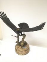 A Quality modern bronze of an Eagle with open wings perched on a parcel gilt bronze naturalistic
