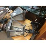A pair of wrought iron external lamps, approx height one metre. Shipping category D.