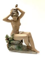 A large Lladro figure of a seated nude lady, 47cm.
