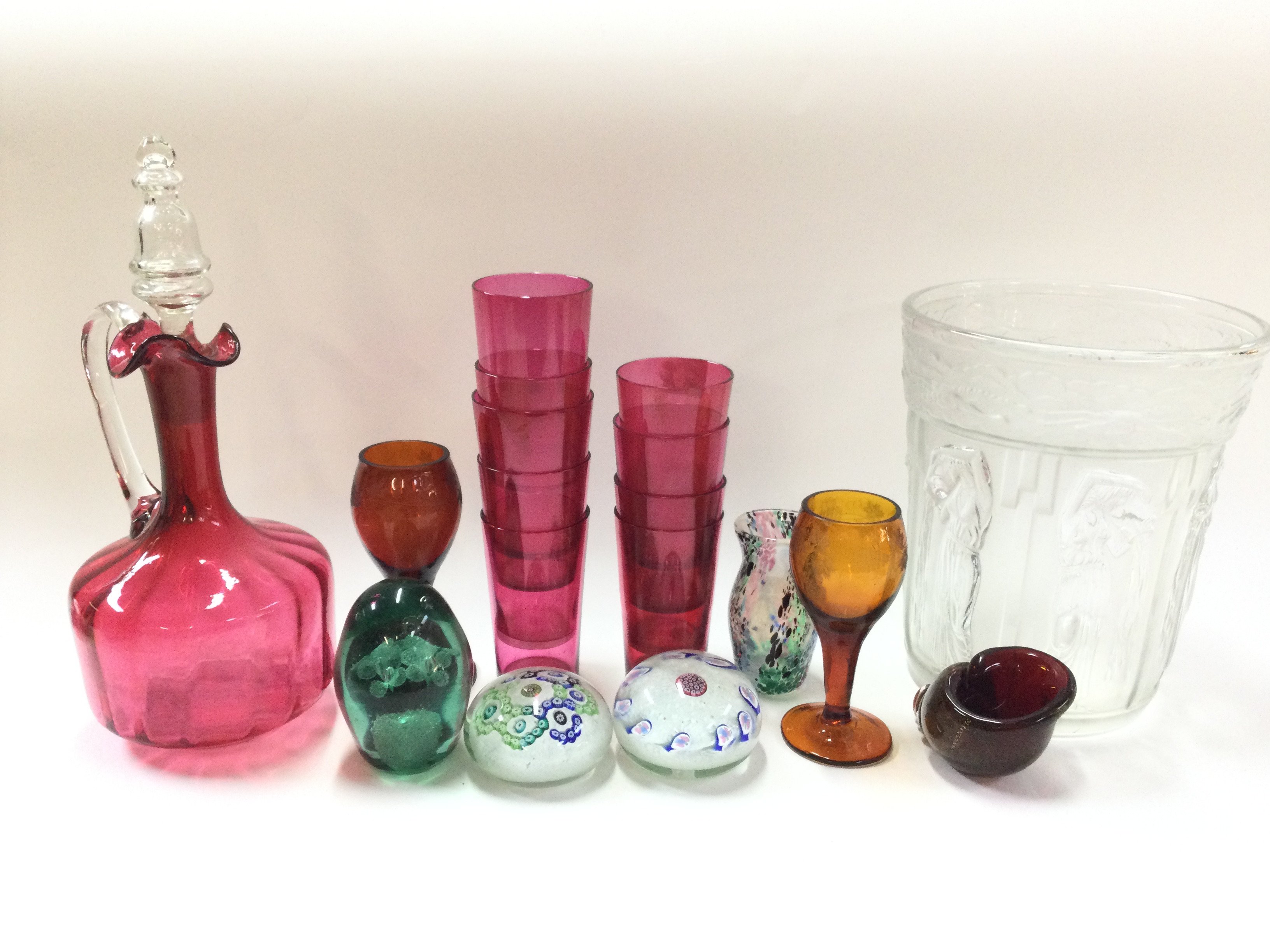 A collection of glassware including cranberry glas