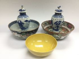 A pair of blue and vases and covers, a famille ros