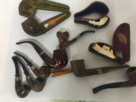 A collection of Meerchaum and other vintage tobacco pipes.