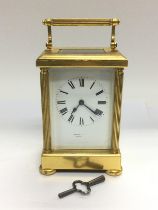 A brass cased carriage clock with key. Shipping category D.